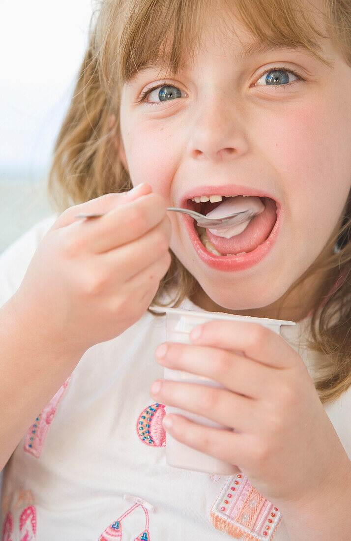 Young Girl Eating Yogurt