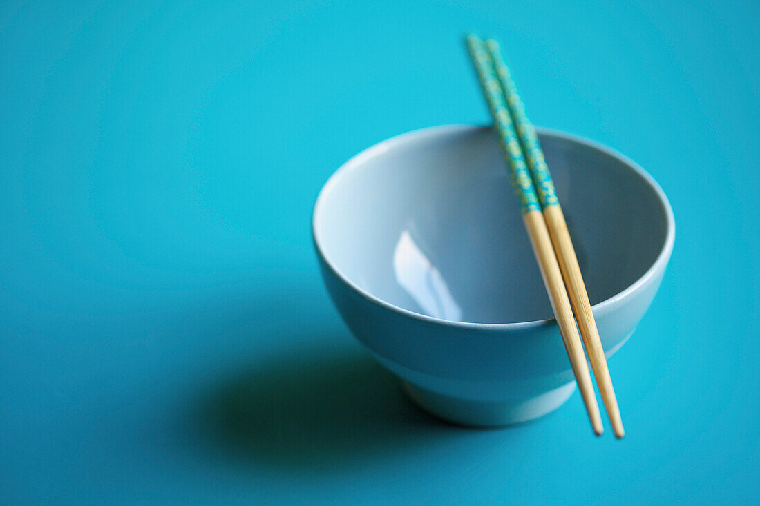 Empty Blue Bowl with Chopsticks