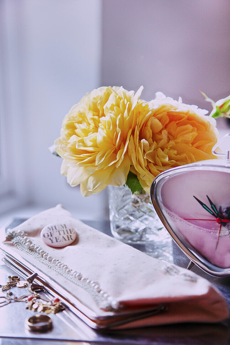 Handbag, Clock, Jewelry and Flowers on Woman's Dressing Table