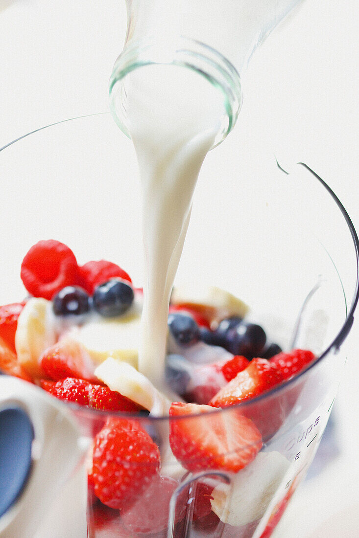 Milk being Poured over Mixed Fruit