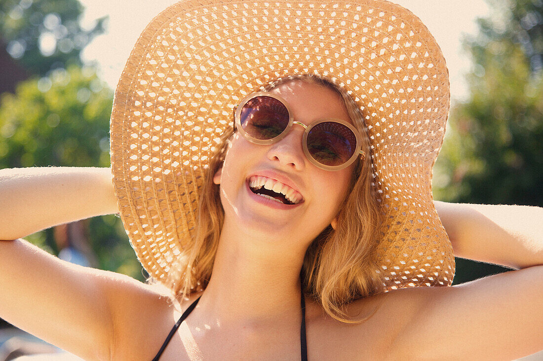 Young Woman Wearing Straw Hat Smiling