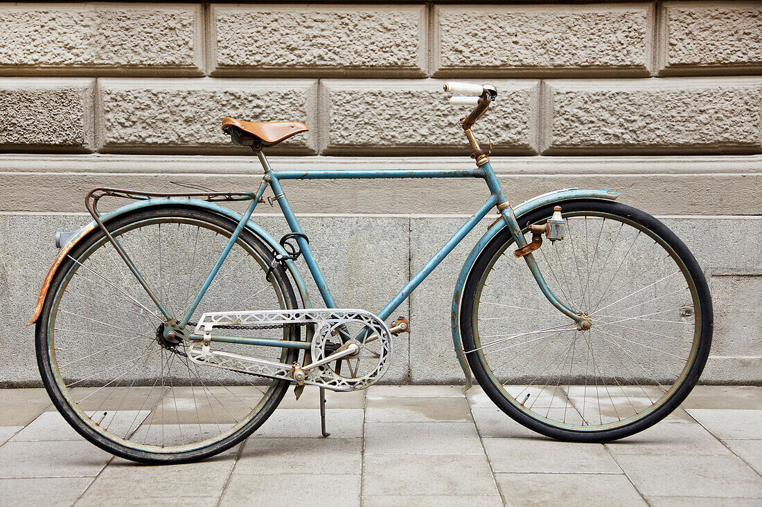 Old Bicycle Parked beside Stone Wall