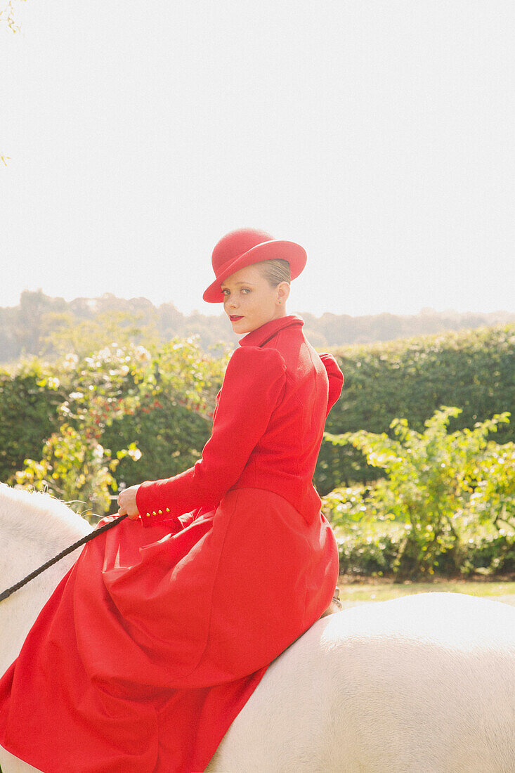 Woman in Red Equestrian Outfit Sidesaddle Riding