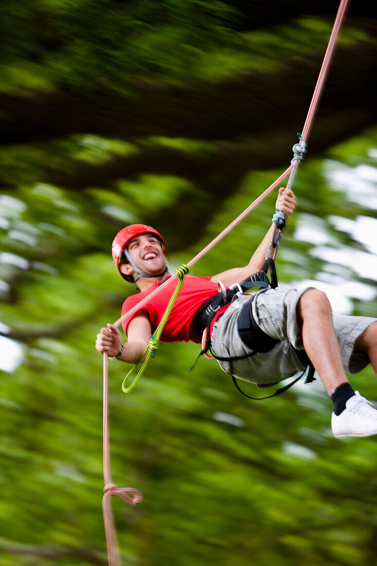 Man dangling from a rope suspended mid air