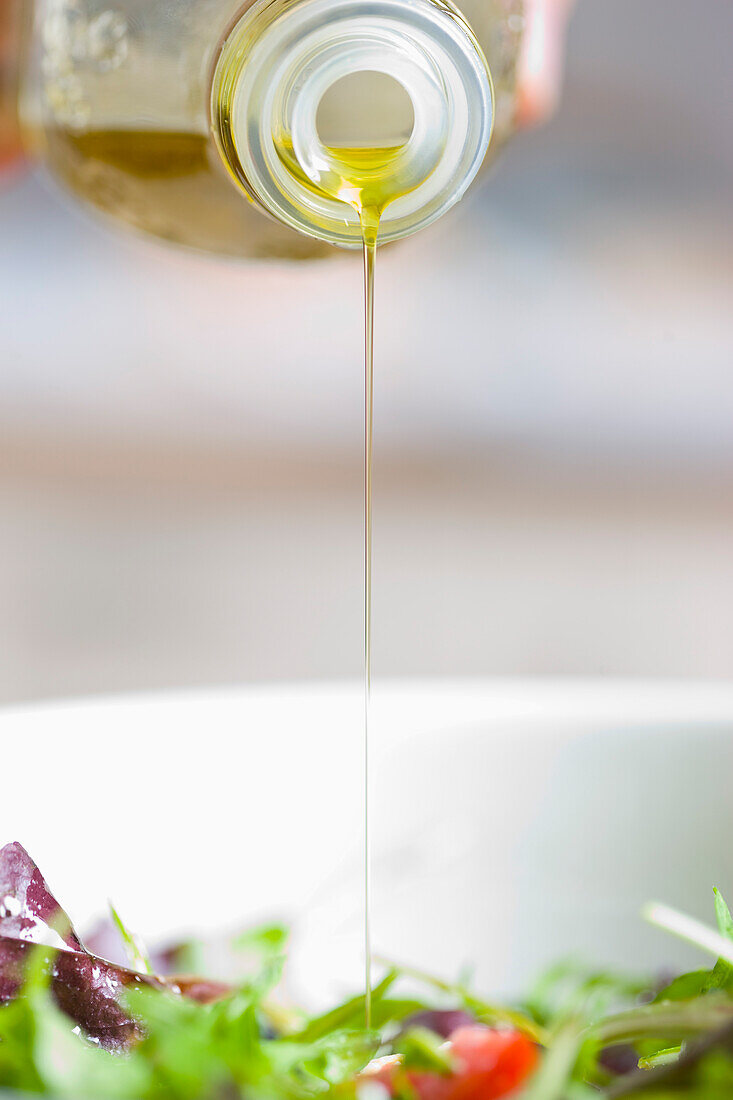 Olive oil drizzle over mixed salad