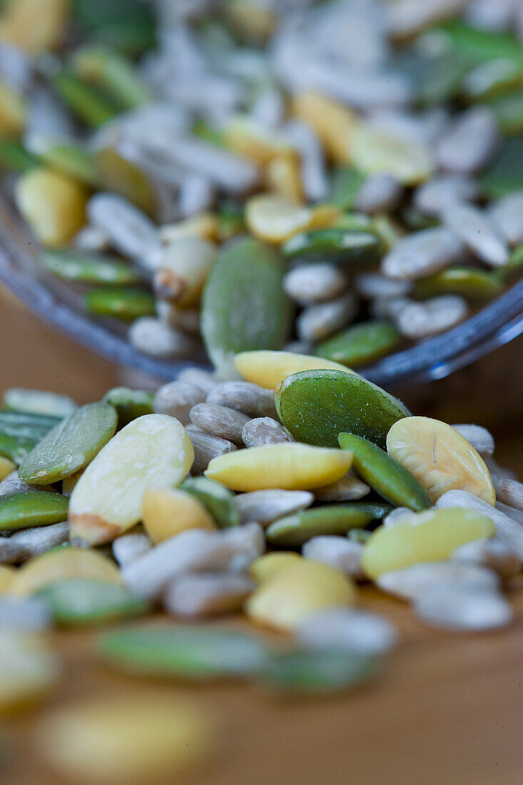 Close up of mixed seeds spilling out of a container