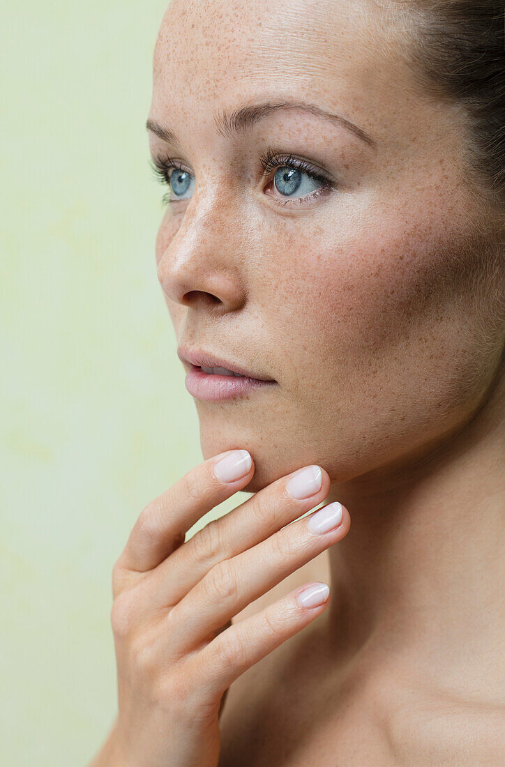 Beauty Portrait of Woman with Hand on Chin