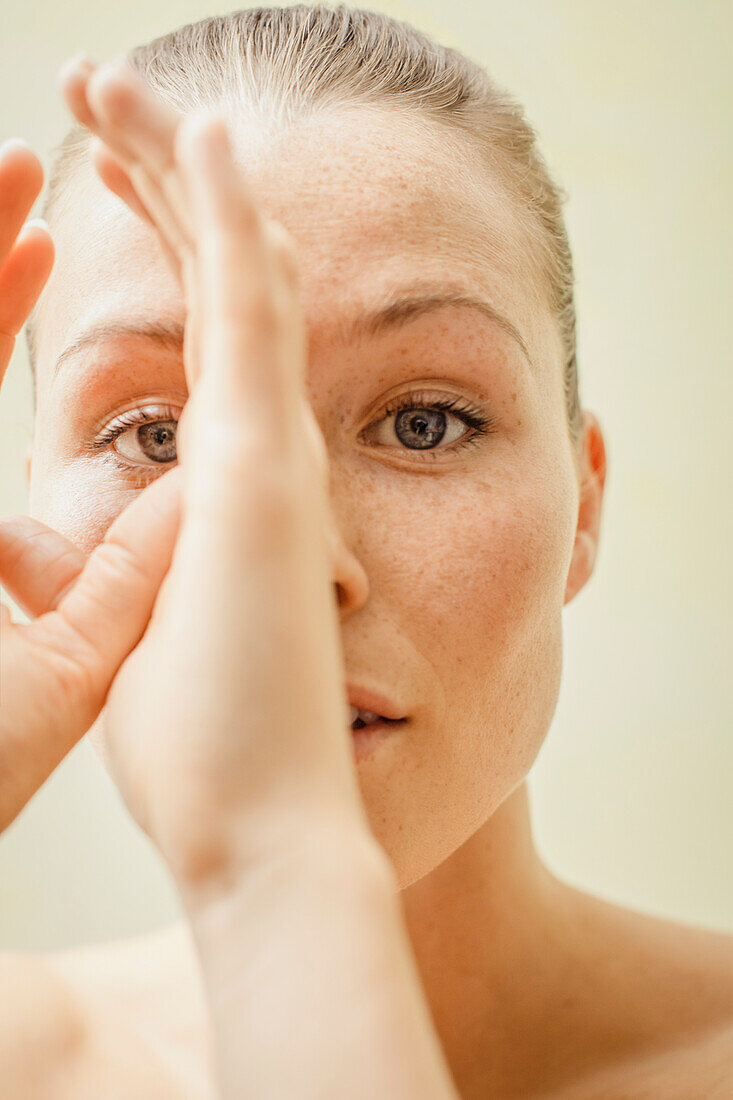 Beauty Portrait of Woman with Hands on Face