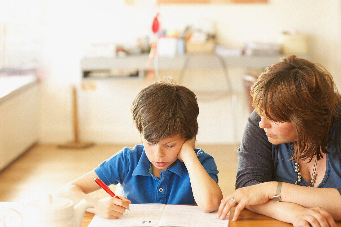 Mother and Son Doing Homework at Kitchen Table