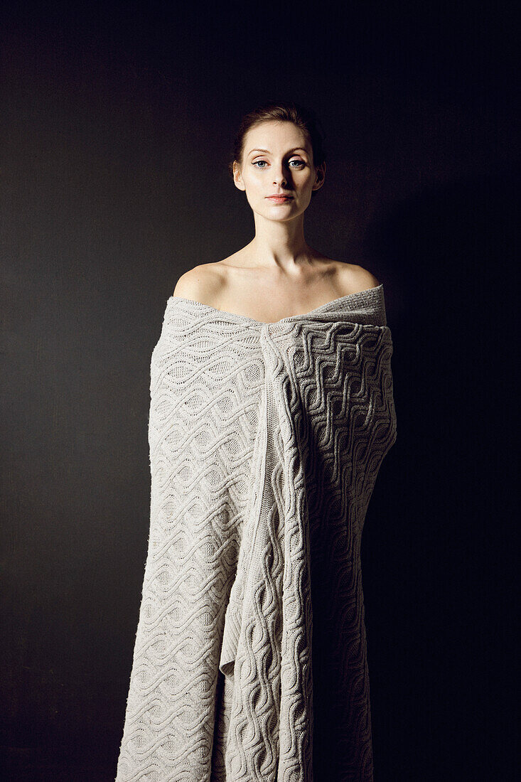 Young Woman Wrapped in Blanket