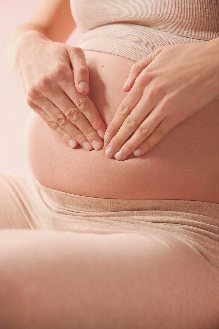 Tapotement Therapeutic Massage, Pregnant Woman Massaging her Stomach