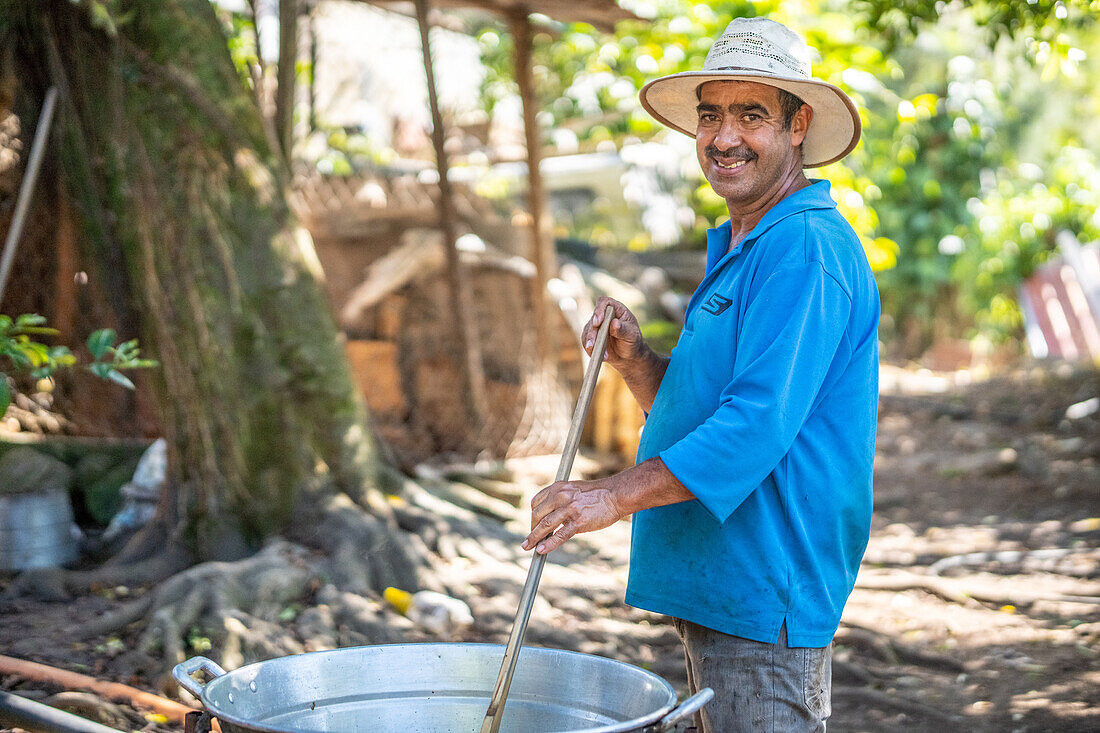 Man making homemade Pork Rind in his home in Hoja Blanca, Guatemala