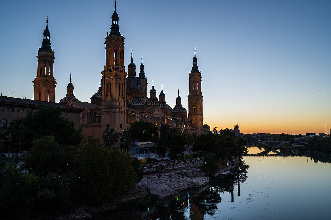 Cathedral-Basilica of Our Lady of the Pillar and the Ebro River bank at sunset, Zaragoza, Spain