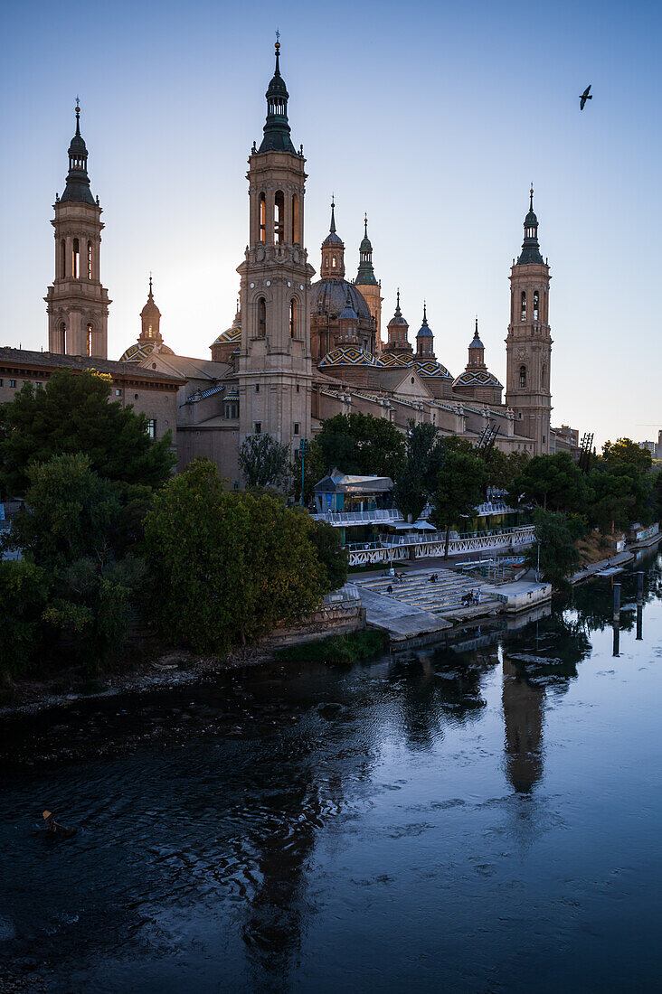 Cathedral-Basilica of Our Lady of the Pillar and the Ebro River bank at sunset, Zaragoza, Spain