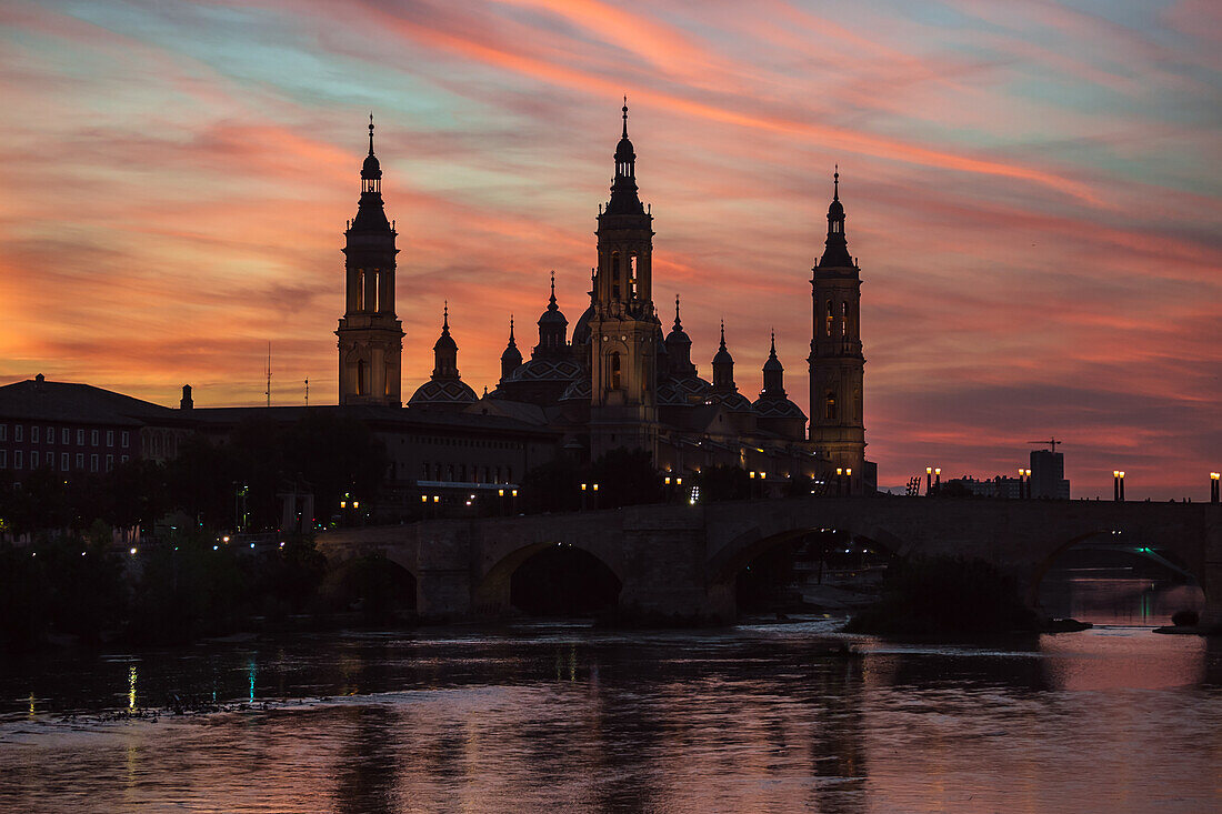 Cathedral-Basilica of Our Lady of the Pillar and the Ebro River bank at sunset, Zaragoza, Spain