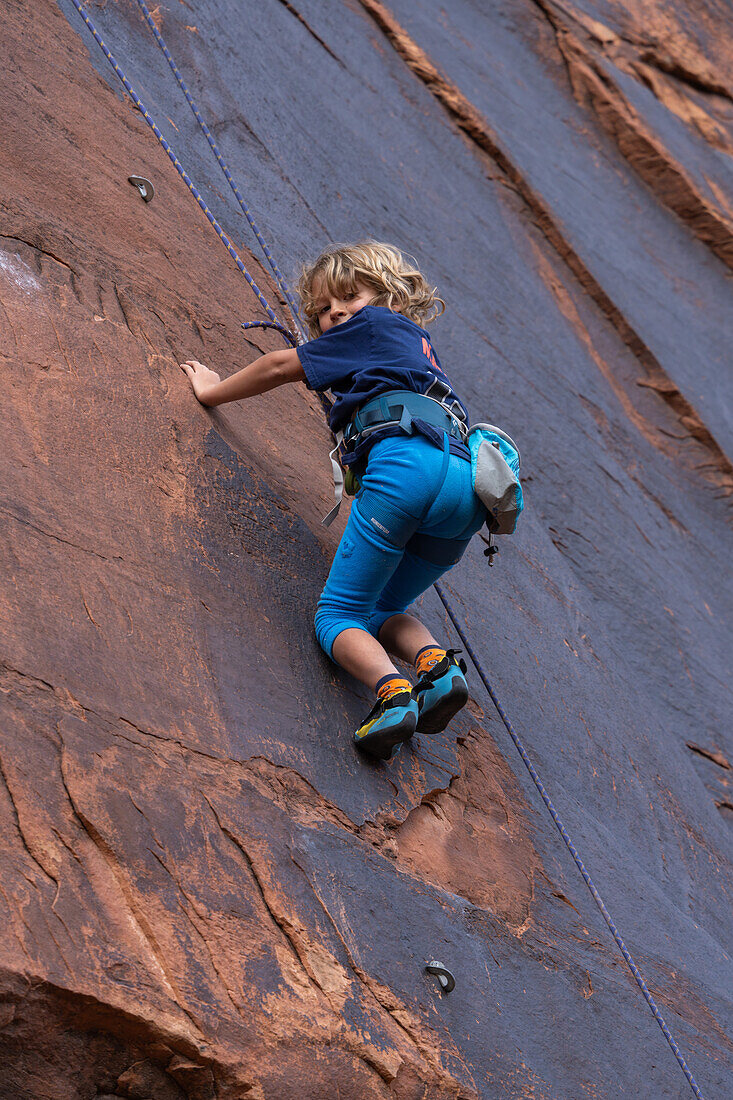 A young boy, age 6, learning to rock climb in Hunter Canyon near Moab, Utah.