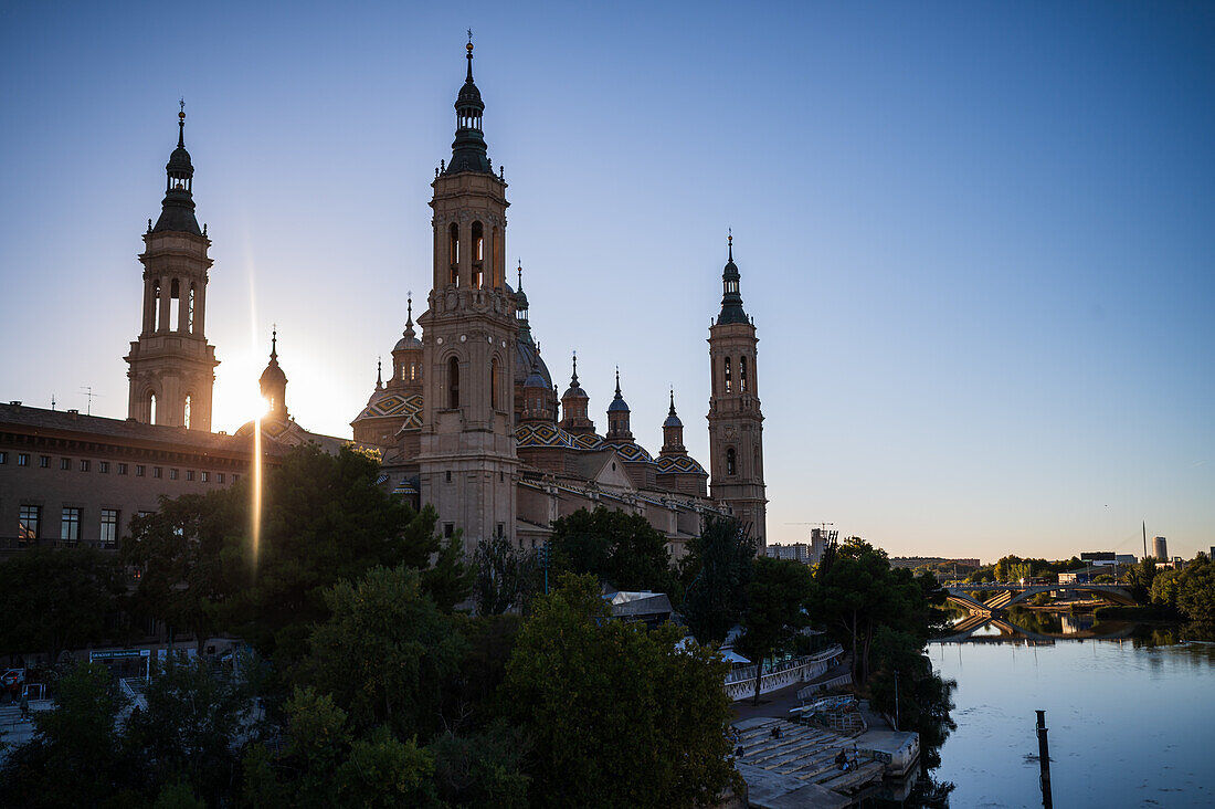 Cathedral-Basilica of Our Lady of the Pillar and the Ebro River bank at sunset, Zaragoza, Spain