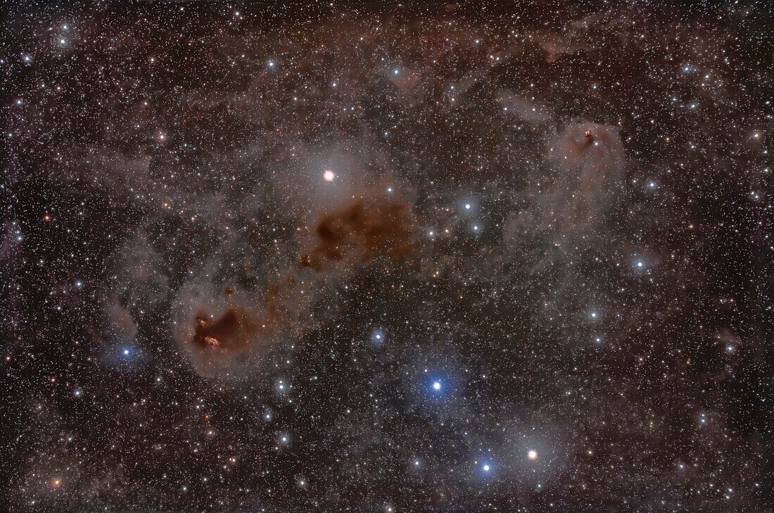 This is a framing of dust clouds among the stars of the Hyades star cluster in Taurus.