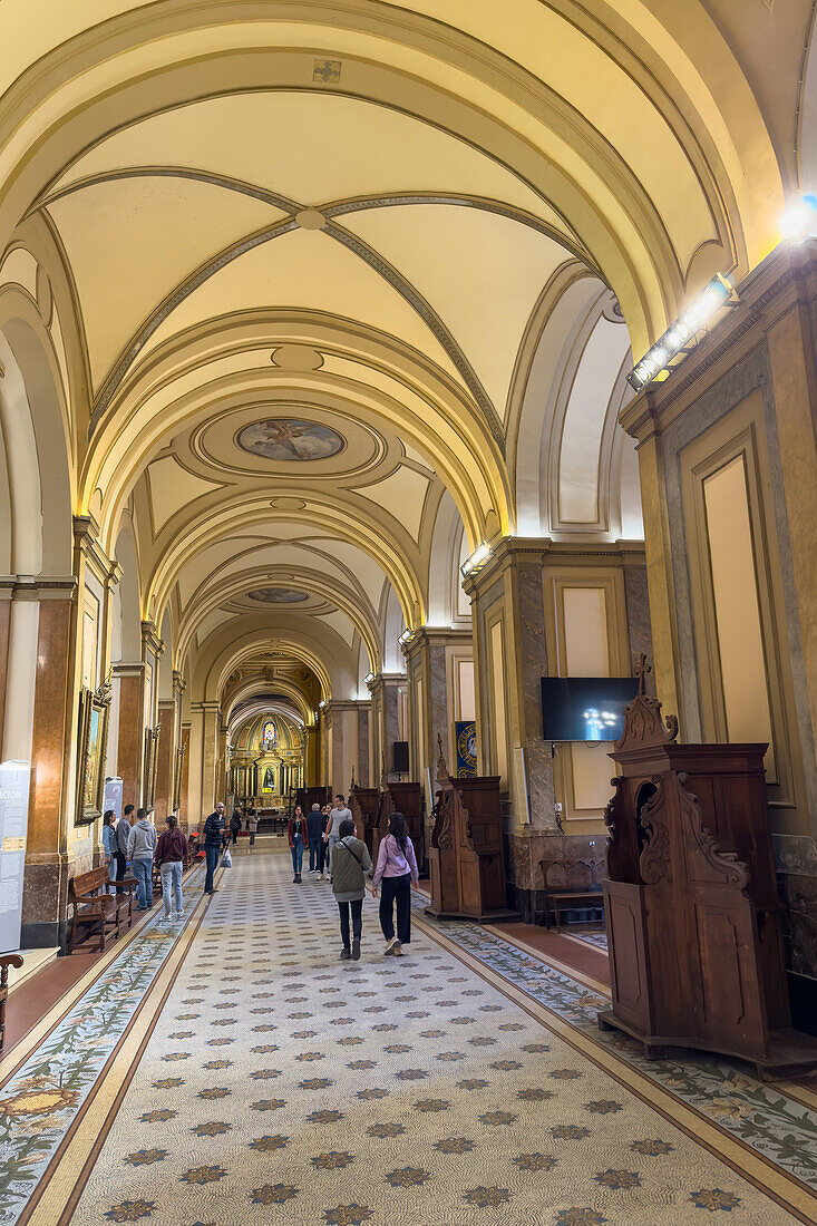 Visitors in the left side nave in the Metropolitan Cathedral, Buenos Aires, Argentina.