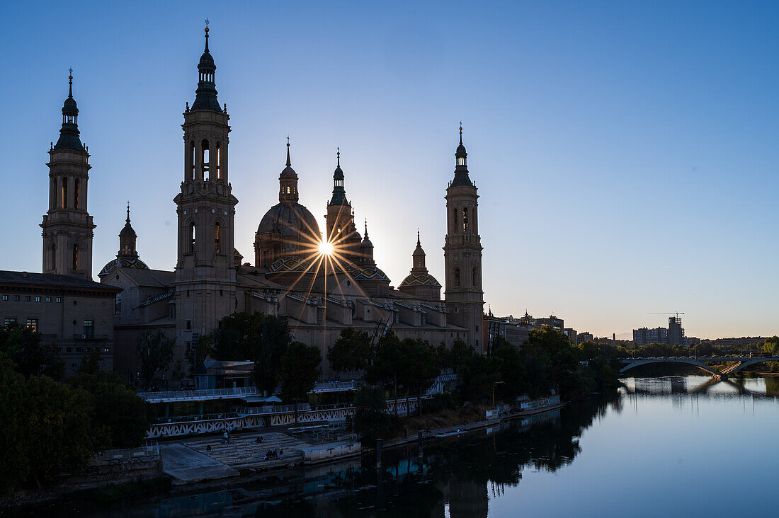 Cathedral-Basilica of Our Lady of the Pillar and the Ebro River bank at sunset, Zaragoza, Spain