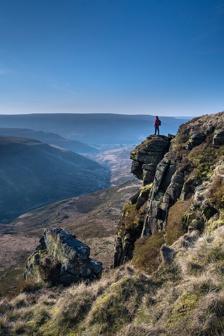 Walker looking over Crowden Great Brook valley from Laddow Rocks, Peak District National Park, Derbyshire, England, United Kingdom, Europe