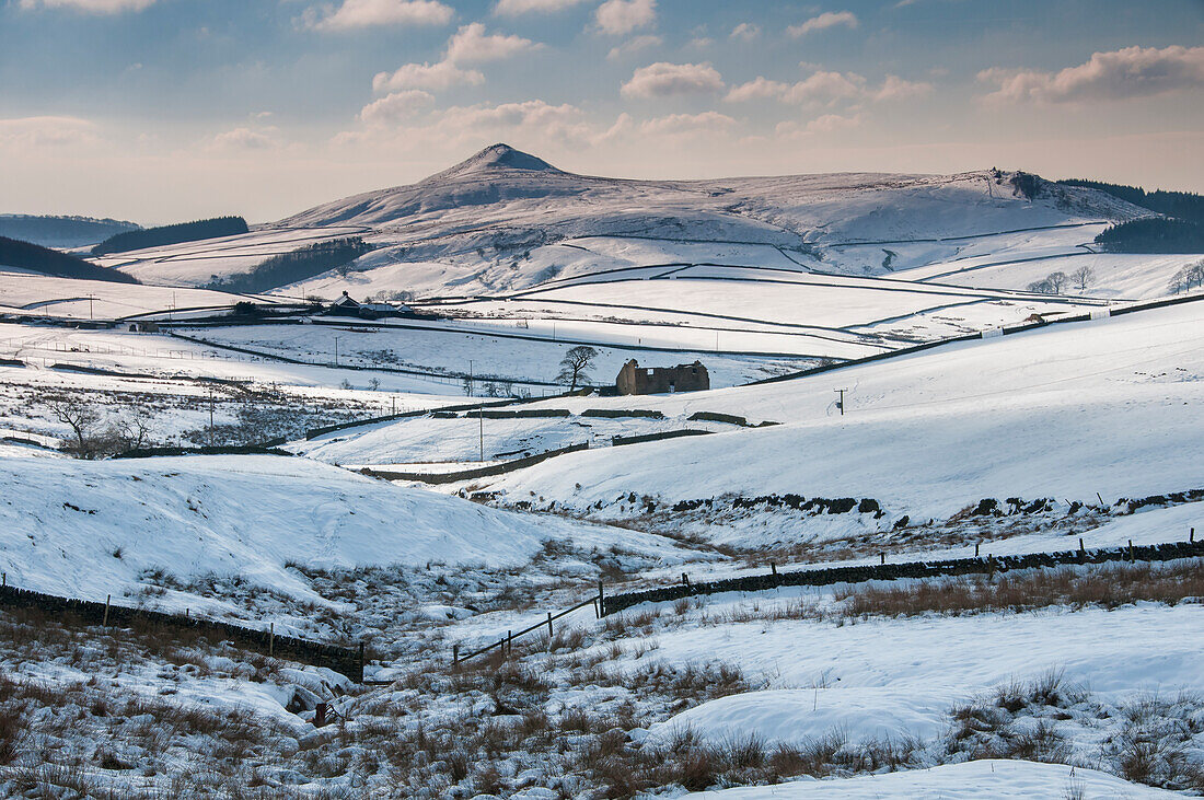 Derelict Barn in Long Clough backed by the peak of Shutlingsloe in winter, Peak District National Park, Cheshire, England, United Kingdom, Europe