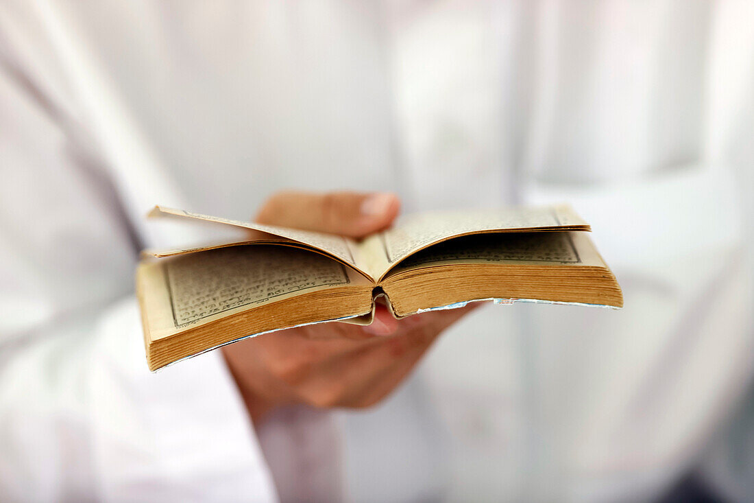 Muslim man reading an Arabic Holy Quran (Koran), Jamiul Azhar Mosque, Vietnam, Indochina, Southeast Asia, Asia