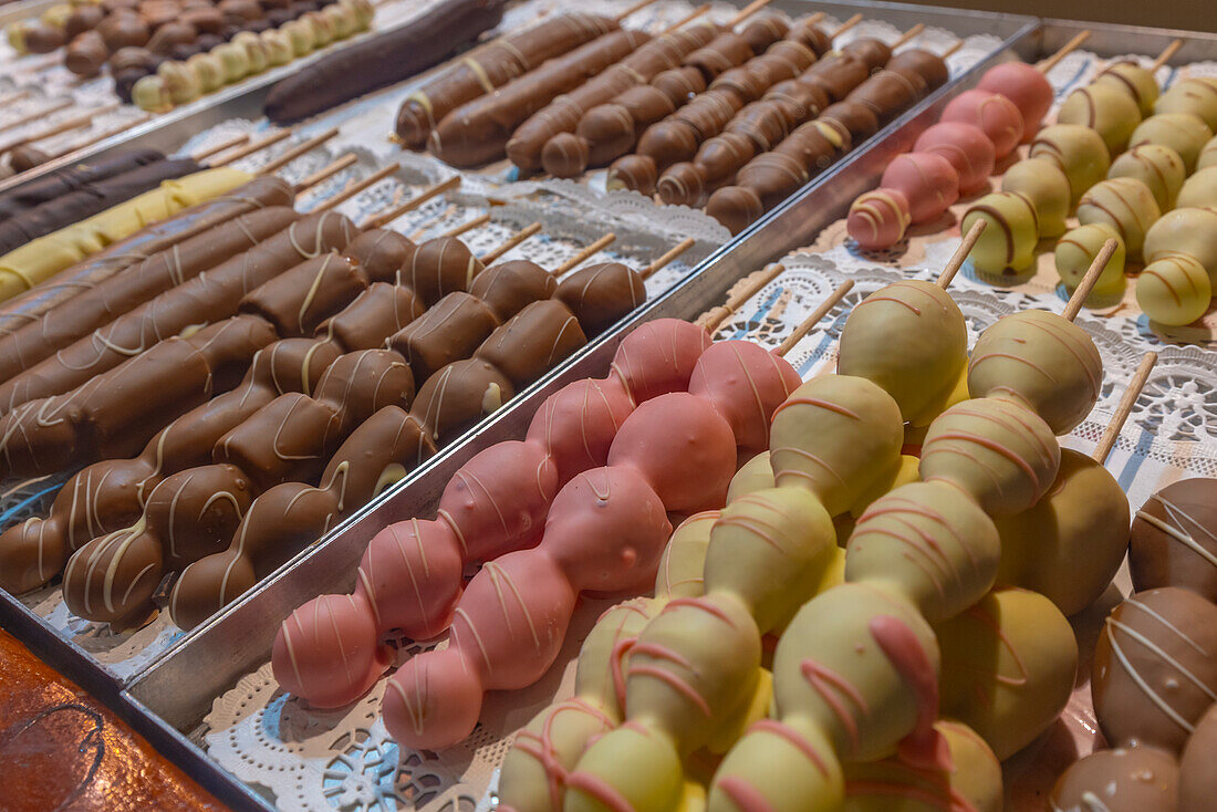 View of chocolates on Christmas Market stall in Victoria Square at dusk, Birmingham, West Midlands, England, United Kingdom, Europe