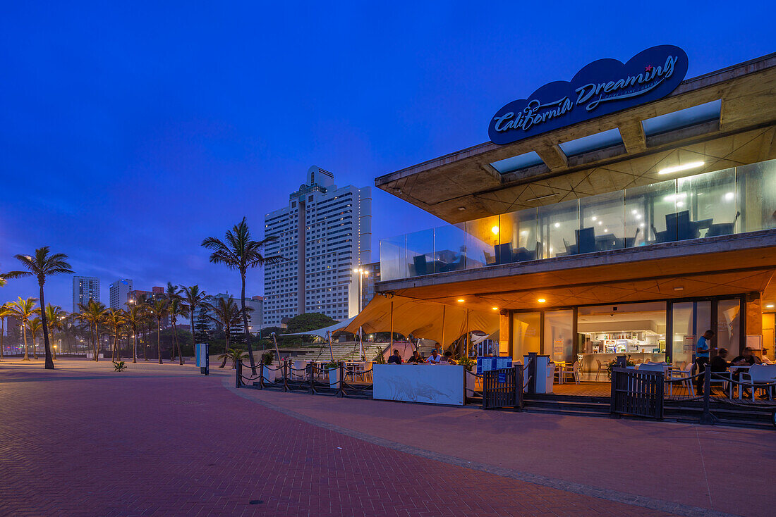 View of promenade restaurant and hotels from New Pier at dusk, Durban, KwaZulu-Natal Province, South Africa, Africa