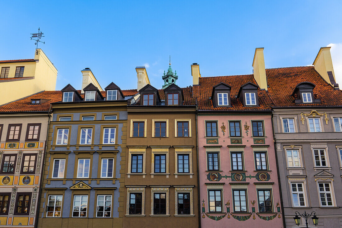 Low angle view of traditional low-rise roof-tiled Burghers houses with facade decorations in the Old Town Market Square (Rynek Starego Miastra), UNESCO World Heritage Site, Warsaw, Poland, Europe