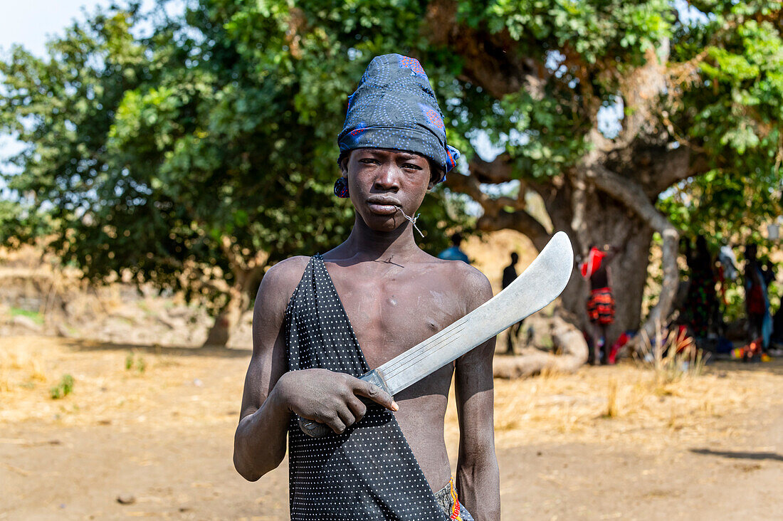 Young Mundari boy holding a machete, Mundari tribe, South Sudan, Africa