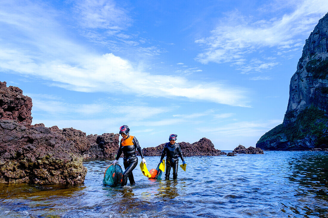 Haenyeo women, famous for diving into their eighties and holding their breath for up to two minutes, diving for conch, octopus, seaweed, and other seafood, Jeju, South Korea, Asia