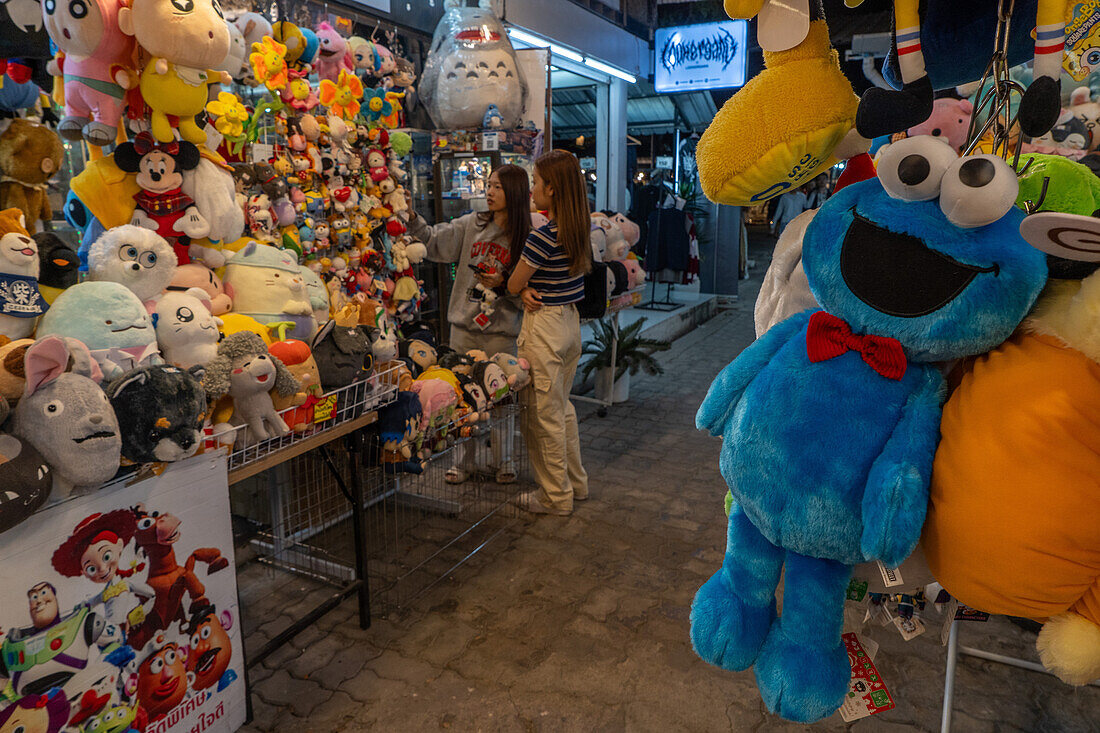 Customers buying soft toys at a night market in Bangkok, Thailand, Southeast Asia, Asia