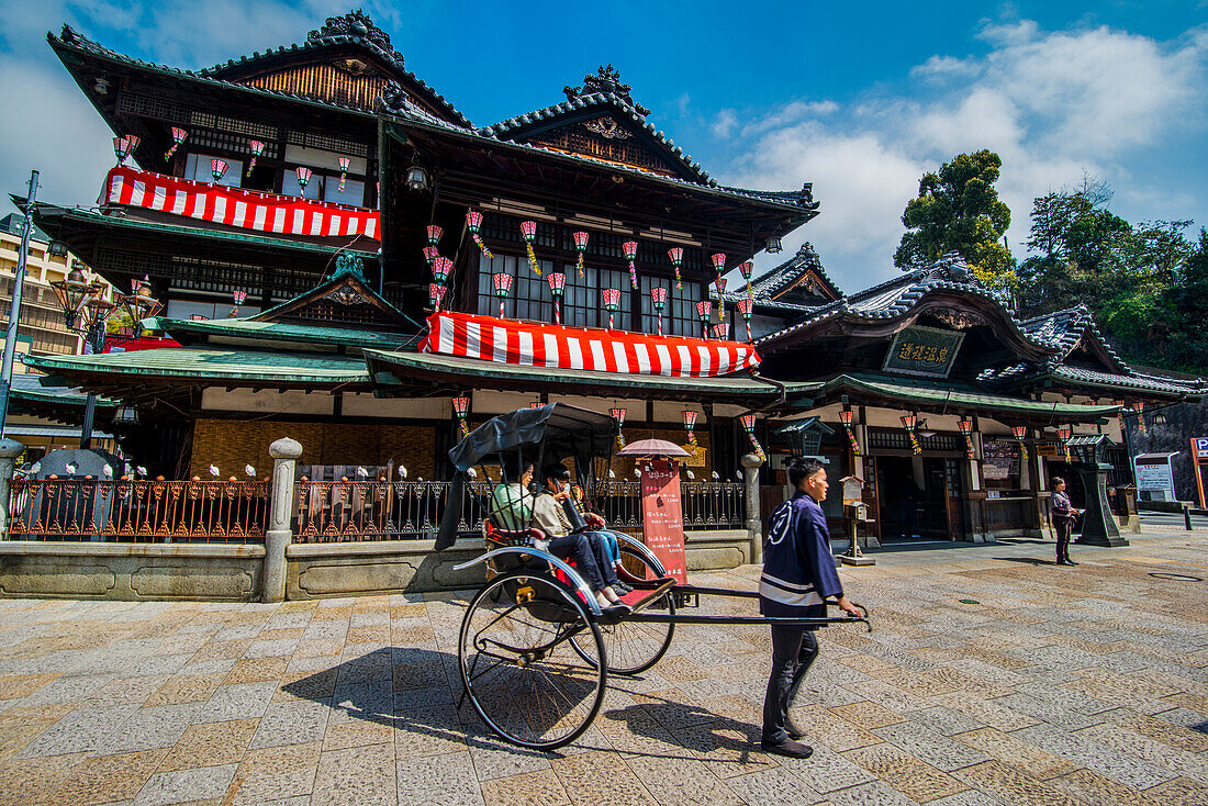 Japanese rickshaw in front of the Dogo Onsen old spa, Matsuyama, Shikoku, Japan, Asia