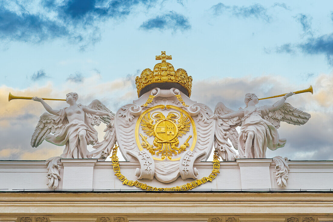 Habsburg coat of arms emblem with sculptures on the roof of Hofburg Palace - Reich Chancellery wing - in Vienna, Austria, Europe