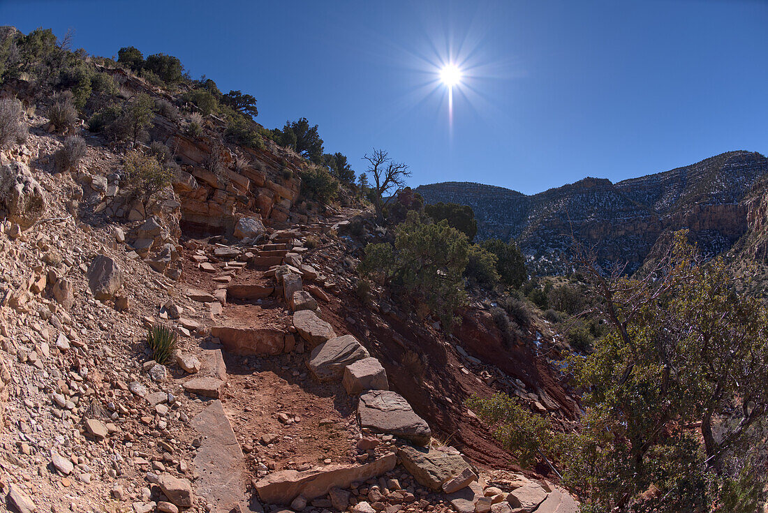 The very rocky pathway of the unmaintained Hermit Canyon Trail at Grand Canyon in winter with Waldron Canyon on the left in the distance, Grand Canyon, Arizona, United States of America, North America