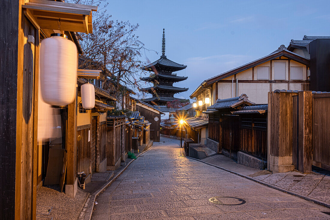 Traditional Hokan-ji Gojunoto Pagoda towering over narrow city street at blue hour, Kyoto, Honshu, Japan, Asia