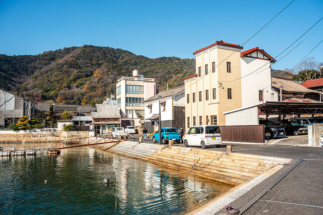 Building at the water front of Tomonoura, with a turquoise water basin in front, Tomonoura, Honshu, Japan, Asia