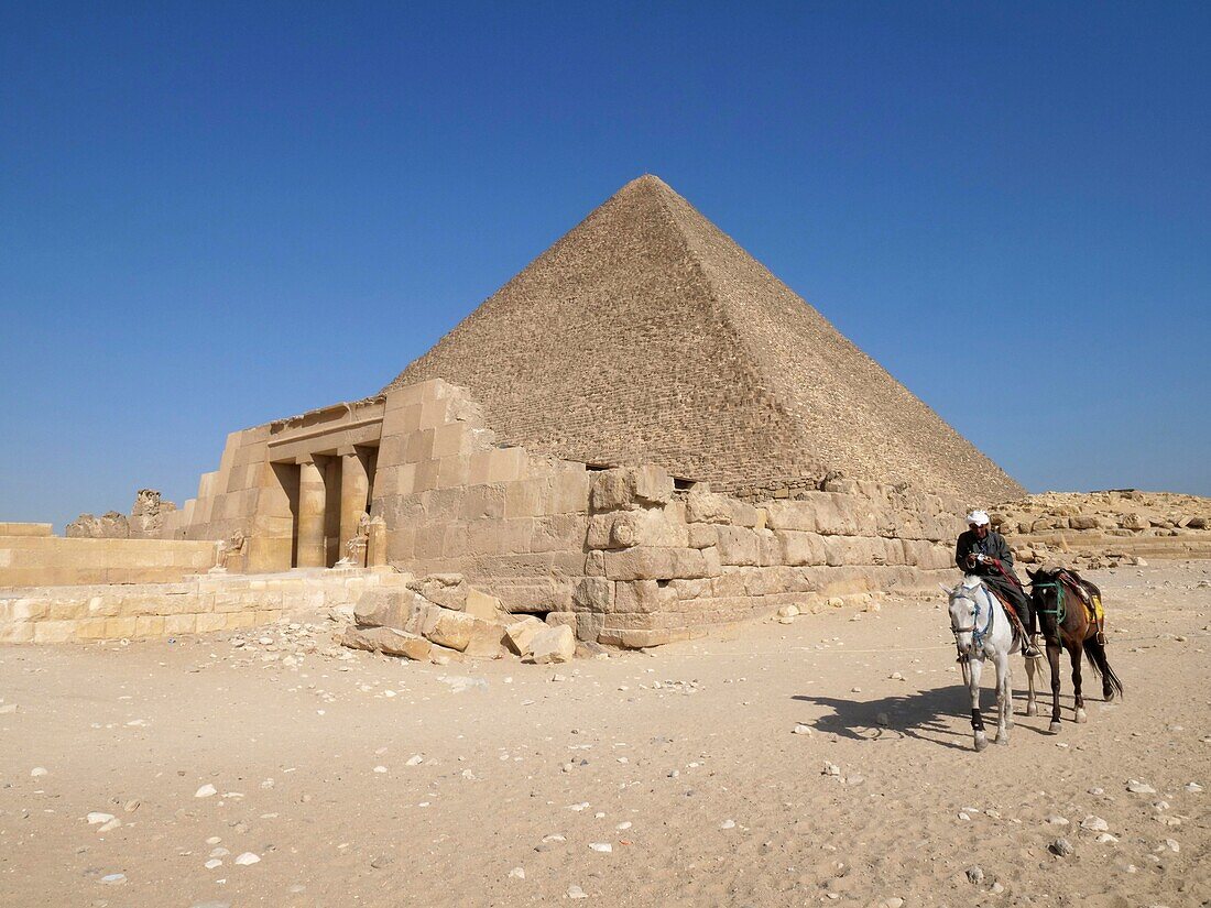 Egypt, Cairo, Giza, UNESCO World Heritage Site, Pyramids of Giza, the pyramid of Cheops and a horseman and his two horses