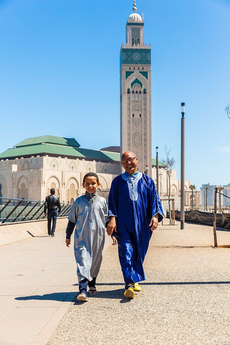 Morocco, Casablanca, square of the Hassan II mosque, father and son at the return of the Friday prayer