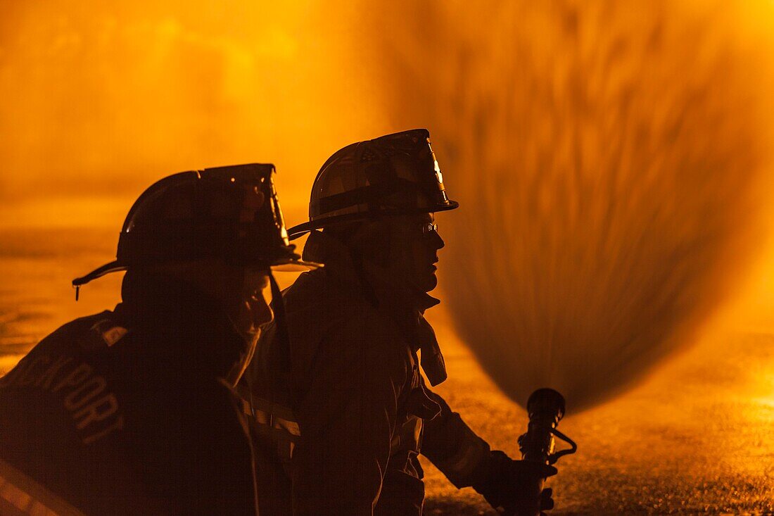 United States, New England, Massachusetts, Cape Ann, Rockport, Rockport Fourth of July Parade, Firemen silhouettes by holiday bonfire