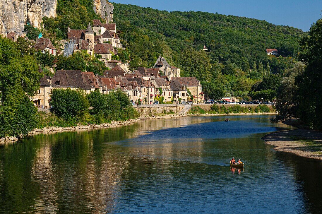 France, Dordogne, La Roque Gageac, houses along the Dordogne river and in background the castle of Malartrie