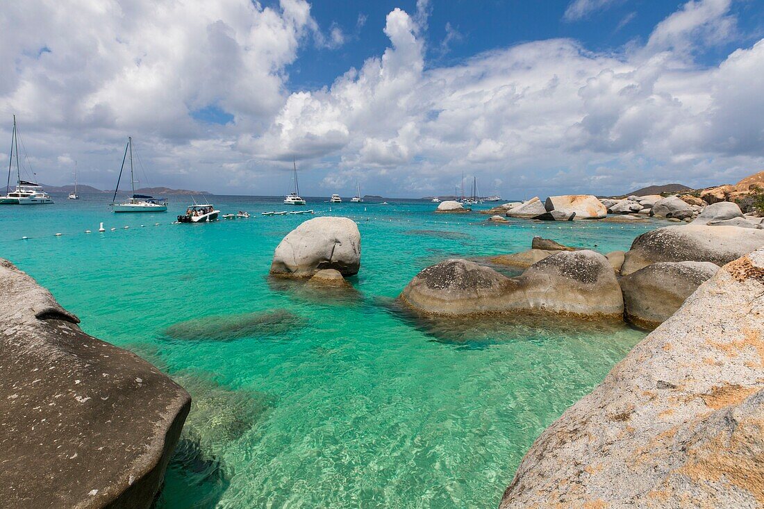 West Indies, British Virgin Islands, Virgin Gorda Island, The Baths, view of the bathing beach, sailboats and motor boat at anchor, in the foreground the typical rocks that surround the paradisiacal swimming area