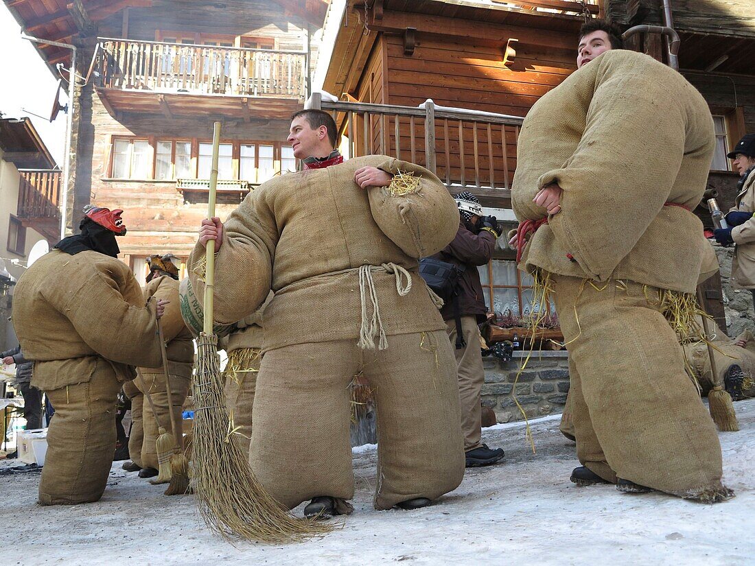 Switzerland, Valais Canton, Val d'Herens, Evolene, Mardi Gras carnival, tradition of the disguised men with bags stuffed with 30 kgs of straw