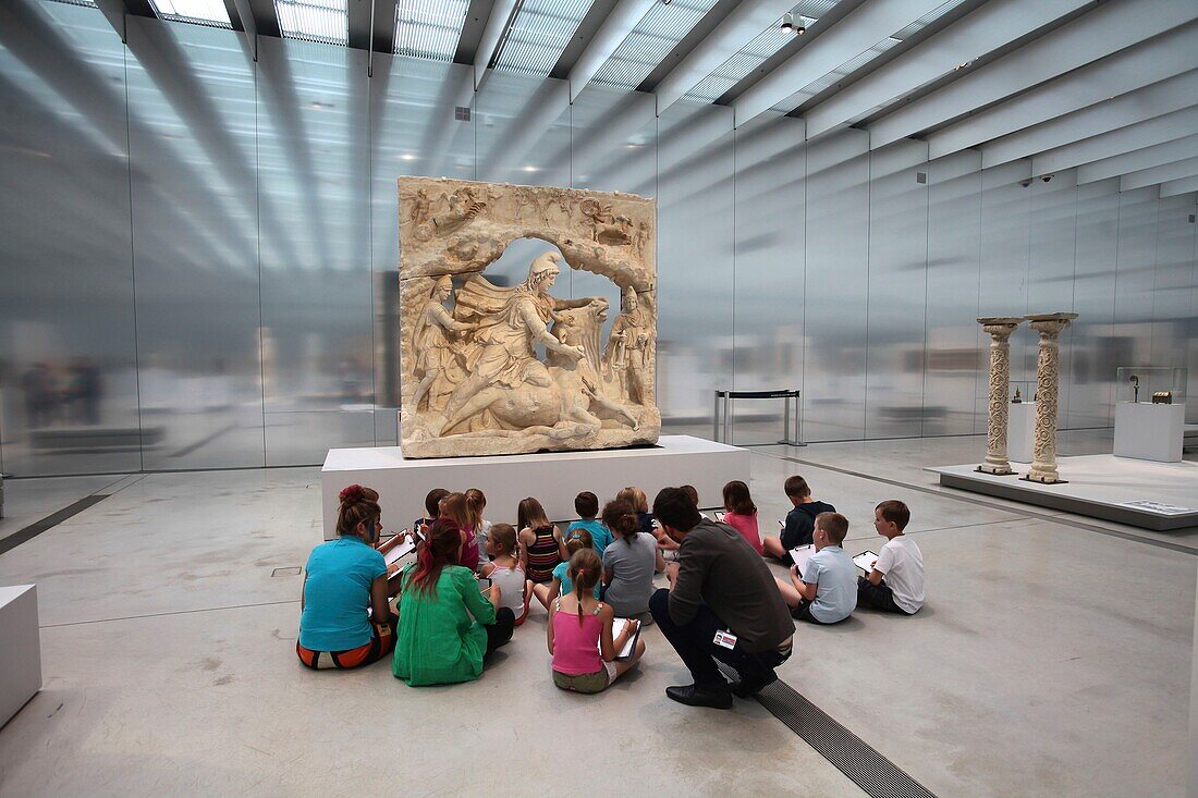 France, Pas de Calais, Lens, Louvre Lens Museum created by the Japanese architecture agency SANAA and architects Celia Imrey and Tim Culbert, a group of children in front of a statue