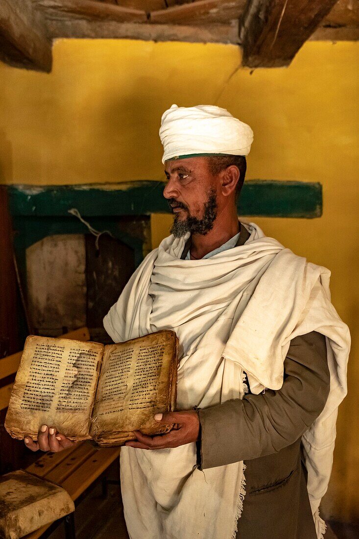 Ethiopia, Tigray regional state, Yeha temple, priest showing a holy book several hundred years old