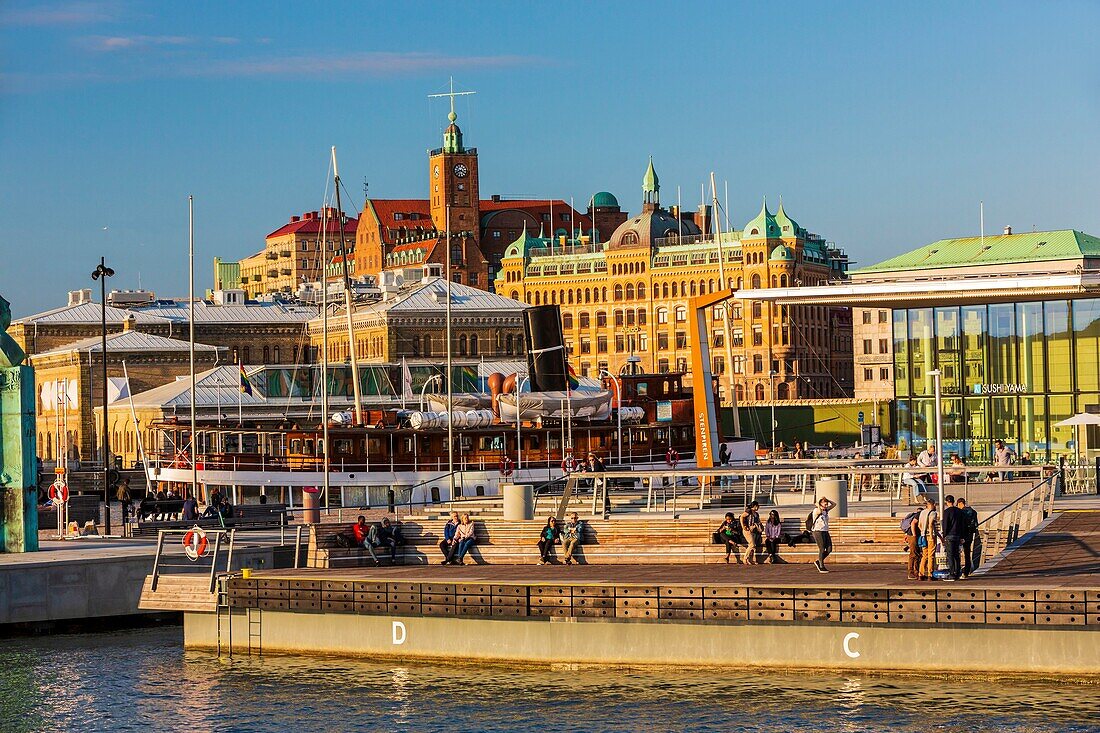 Sweden, Vastra Gotaland, Goteborg (Gothenburg), Stenpiren with a view of the buildings of the company ASECO on Packhusplatsen facing the harbor and Kvarnberget and his clock