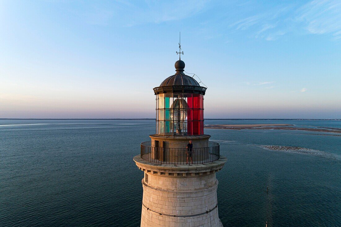 France, Gironde, Verdon-sur-Mer, rocky plateau of Cordouan, lighthouse of Cordouan, classified Historical Monuments, lighthouse keeper at the lantern at sunset (aerial view)