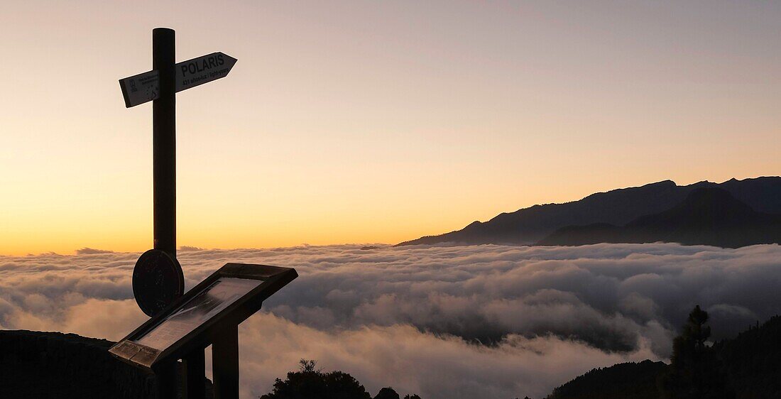 Spain, Canary Islands, La Palma, view of a silhouette of a mountain above a sea of &#x200b;&#x200b;cloud at sunrise