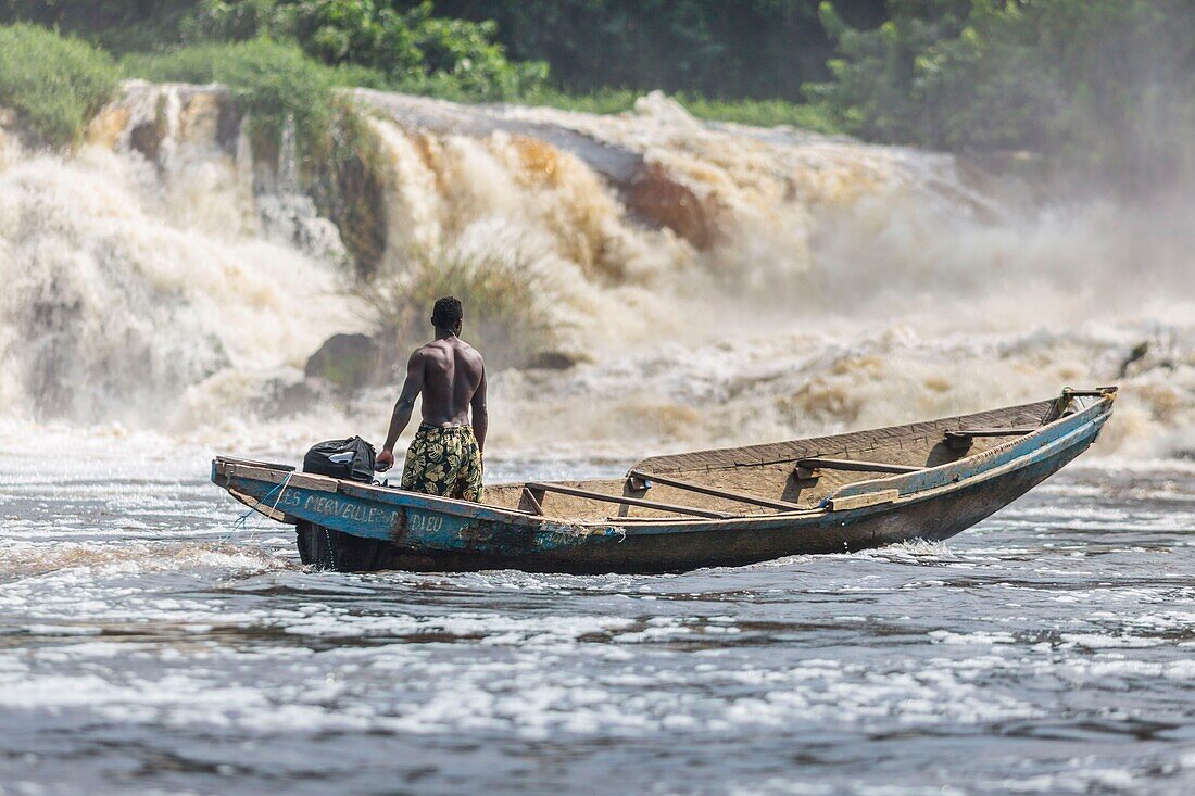 Cameroon, South Region, Ocean Department, Kribi, fisherman in a canoe in front of Lobe Waterfall